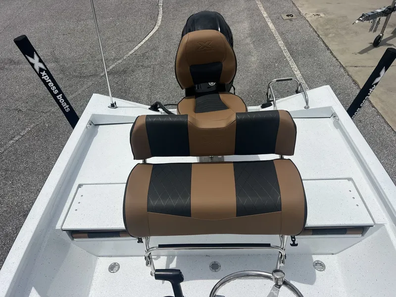 Slide: The Image of 2026 Xpress H20B Bay boat with brown and black seating. - 6