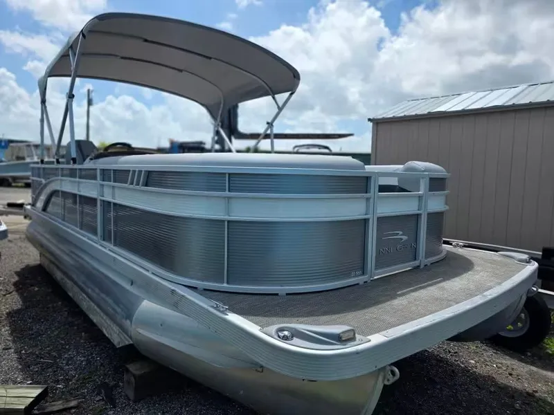 The Image of 2021 Bennington 22SSX pontoon boat with canopy, parked outdoors. - 1