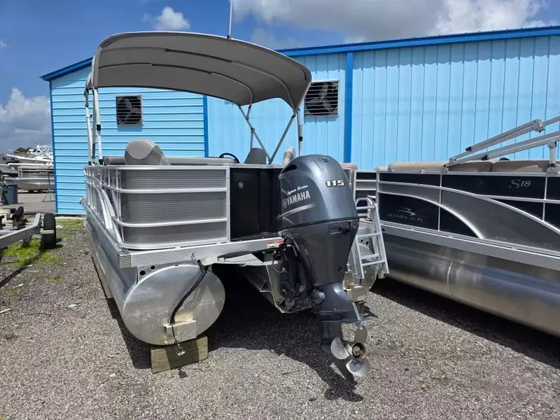 Slide: The Image of 2021 Bennington 22SSX pontoon boat with Yamaha motor, in front of blue building. - 3