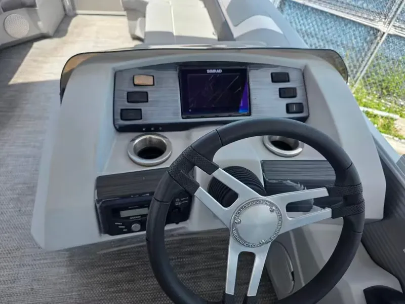 Slide: The Image of Interior view of 2021 Bennington 22SSX helm with steering wheel and controls. - 9