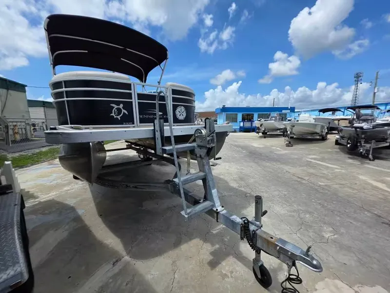 Slide: The Image of 2016 Bennington SX20 pontoon boat on trailer under blue sky. - 3