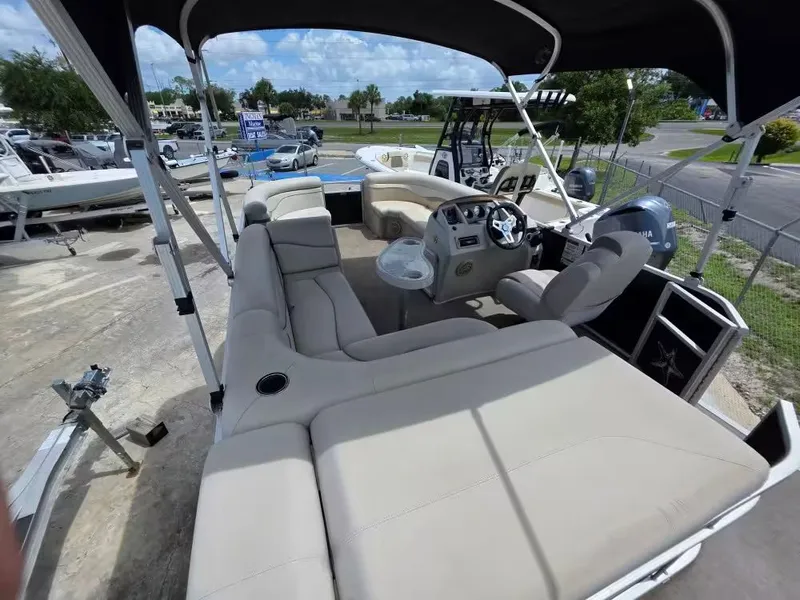 Slide: The Image of 2016 Bennington SX20 pontoon boat with beige interior and helm station. - 5