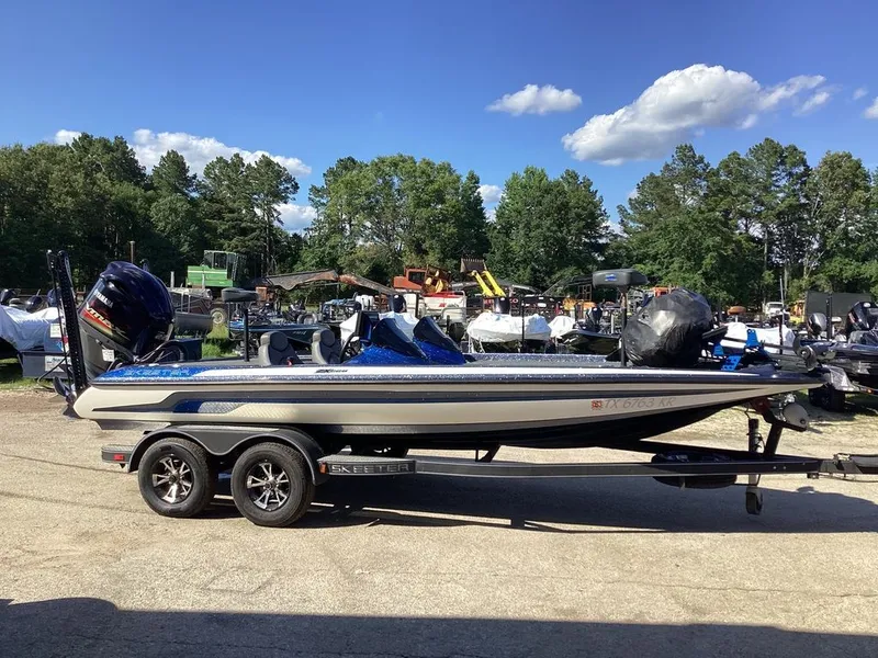 The Image of 2019 Skeeter ZX225 boat on trailer, sunny day, forest background. - 1