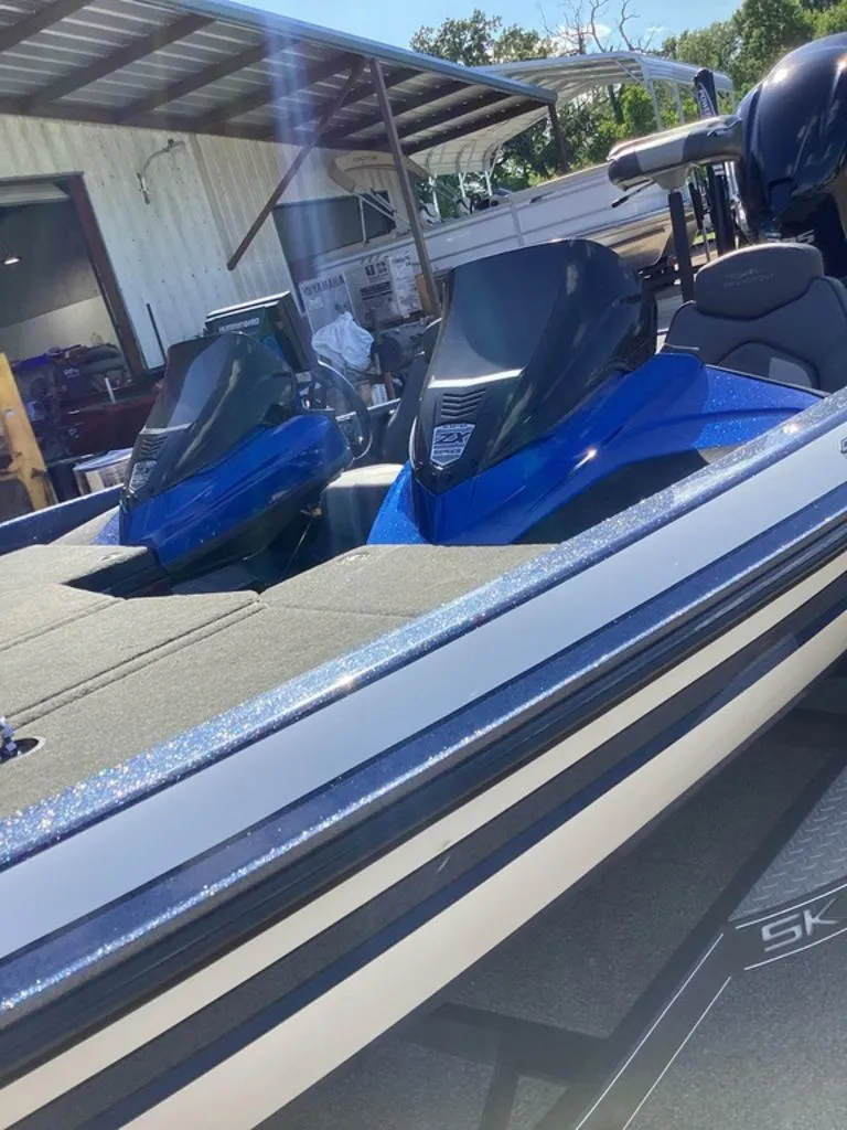 Slide: The Image of 2019 Skeeter ZX225 boat with blue deck, parked outdoors. - 21