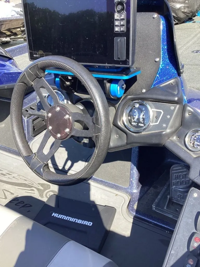 Slide: The Image of Interior of a 2019 Skeeter ZX225 boat with steering wheel and electronics. - 8
