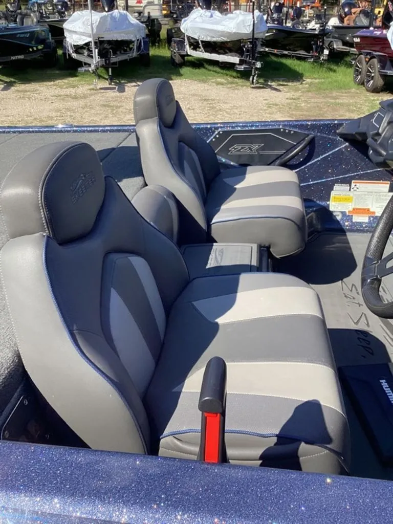 Slide: The Image of Interior of a 2019 Skeeter ZX225 boat with gray seats. - 9