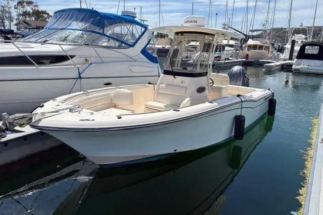The Image of 2023 Grady-White Fisherman 236 boat docked in a marina, surrounded by other vessels. - 0
