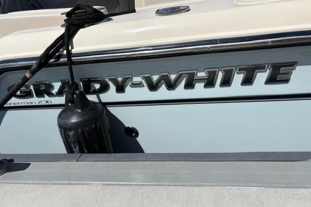 Slide: The Image of 2023 Grady-White Fisherman 236 boat with logo and fender, close-up view. - 5