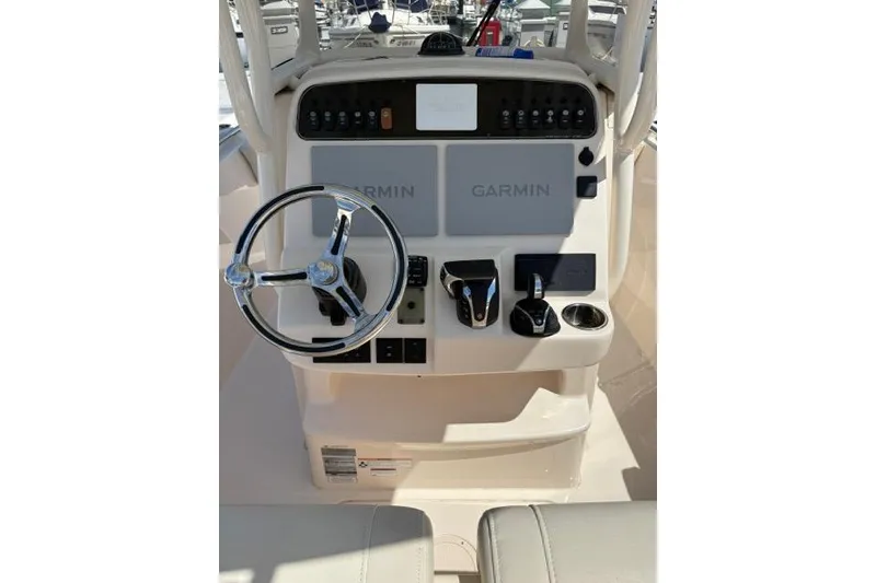 Slide: The Image of 2023 Grady-White Fisherman 236 boat console with Garmin navigation system and steering wheel. - 8