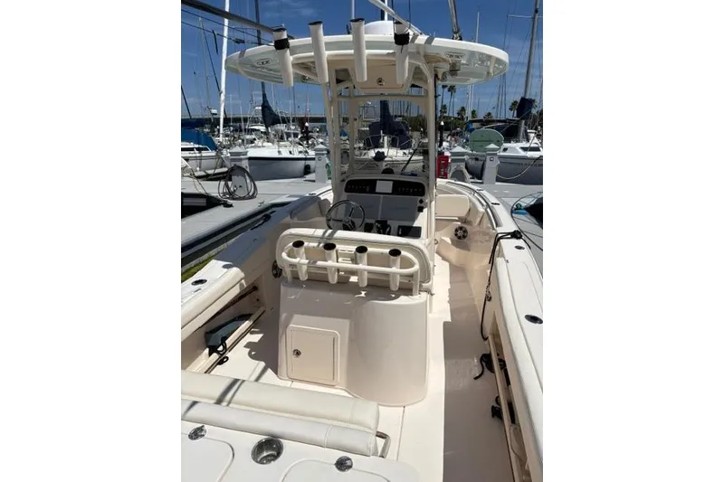 Slide: The Image of 2023 Grady-White Fisherman 236 boat interior at marina, showcasing helm and seating. - 9