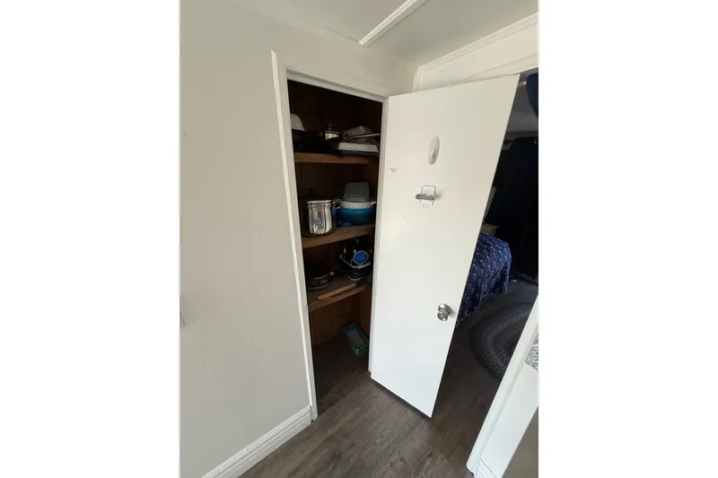 Slide: The Image of Open closet with shelves in a 1986 Hilburn 4014 Executive RV interior. - 12