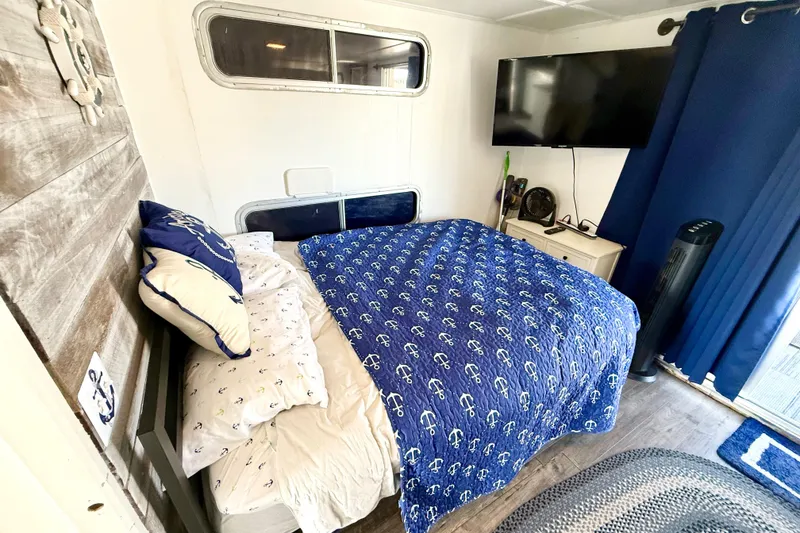 Slide: The Image of Cozy bedroom in 1986 Hilburn 4014 Executive with nautical-themed bedding and modern amenities. - 13