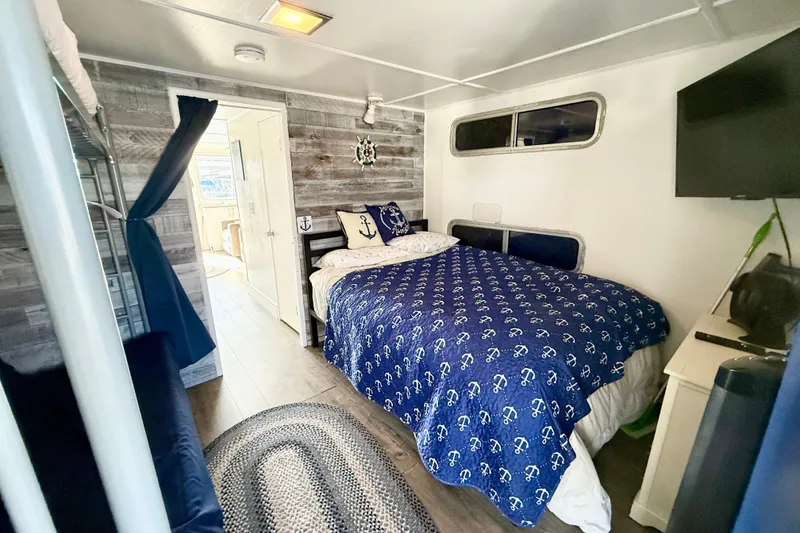 Slide: The Image of Cozy bedroom in 1986 Hilburn 4014 Executive, nautical decor, wood paneling, and modern amenities. - 14