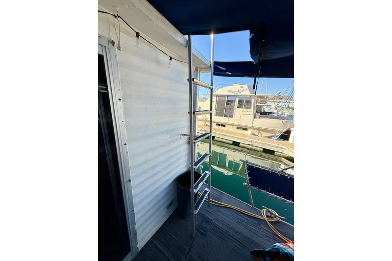 Slide: The Image of 1986 Hilburn 4014 Executive boat with ladder and marina view. - 18