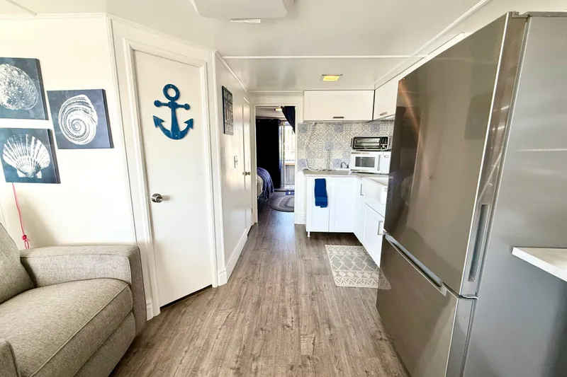 Slide: The Image of Modern kitchen interior in 1986 Hilburn 4014 Executive, featuring nautical decor and stainless steel appliances. - 4