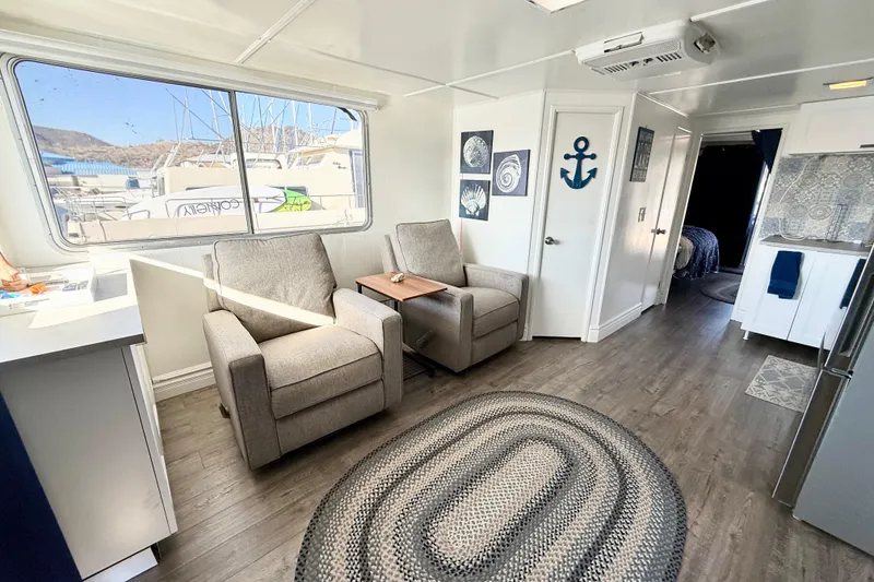 Slide: The Image of Interior of 1986 Hilburn 4014 Executive houseboat with cozy seating and nautical decor. - 5