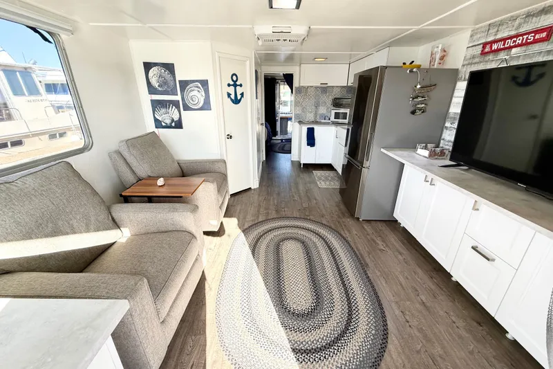 Slide: The Image of Modern interior of a 1986 Hilburn 4014 Executive houseboat with cozy seating and stylish decor. - 9