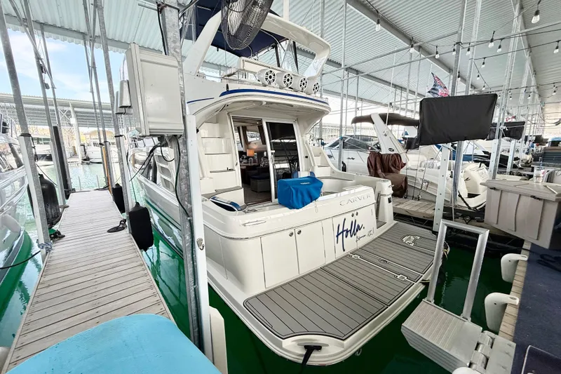Slide: The Image of 2007 Carver 36 Sedan yacht docked in a marina under a covered structure. - 11