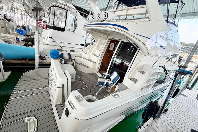 Slide: The Image of 2007 Carver 36 Sedan yacht docked in marina, featuring spacious deck and elegant design. - 12