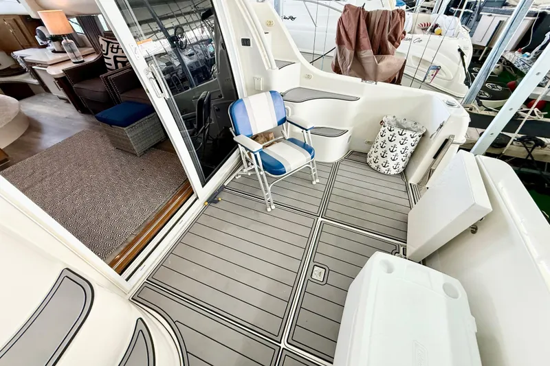 Slide: The Image of 2007 Carver 36 Sedan yacht deck with seating, nautical decor, and interior view. - 15