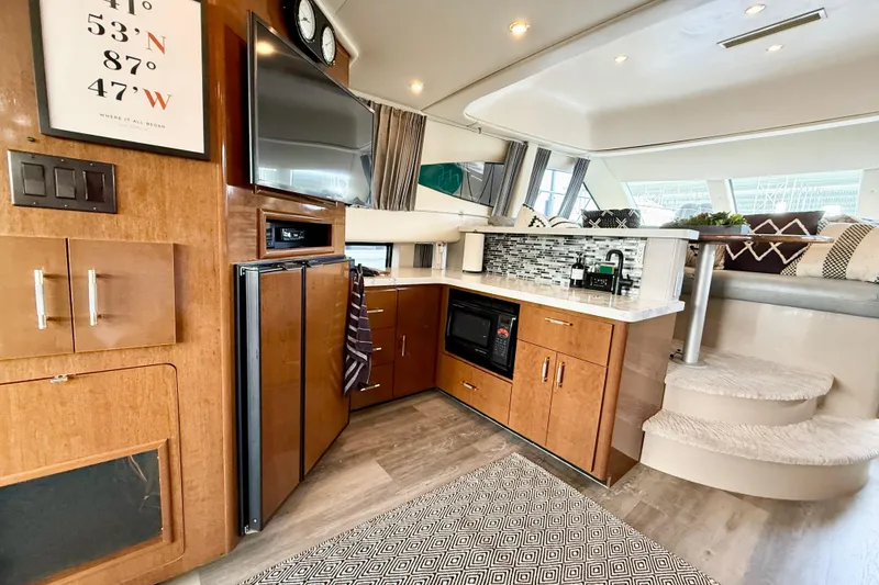 Slide: The Image of Luxurious interior of a 2007 Carver 36 Sedan yacht with modern kitchen amenities. - 18