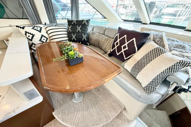 Slide: The Image of Luxurious 2007 Carver 36 Sedan interior with stylish cushions and elegant wooden table. - 23