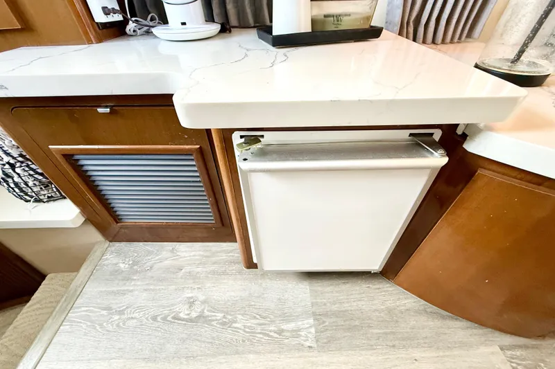 Slide: The Image of 2007 Carver 36 Sedan interior with modern kitchen cabinetry and countertop. - 25