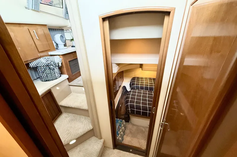 Slide: The Image of Interior of 2007 Carver 36 Sedan with cozy cabin and wooden cabinetry. - 26