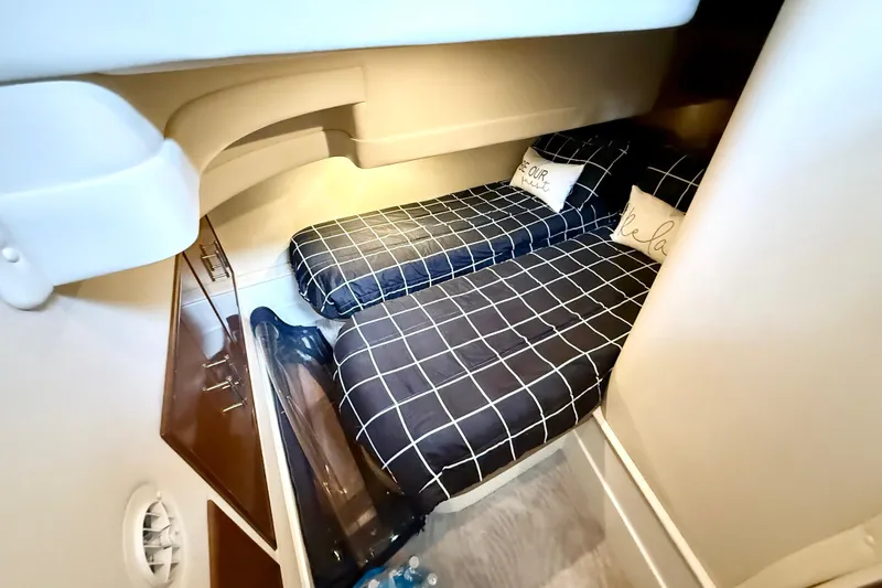 Slide: The Image of Interior cabin of 2007 Carver 36 Sedan with twin beds and checkered bedding. - 31