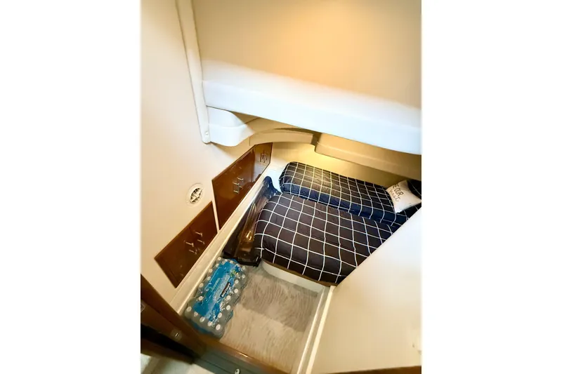 Slide: The Image of 2007 Carver 36 Sedan cabin interior with bed, storage, and water bottles. - 32