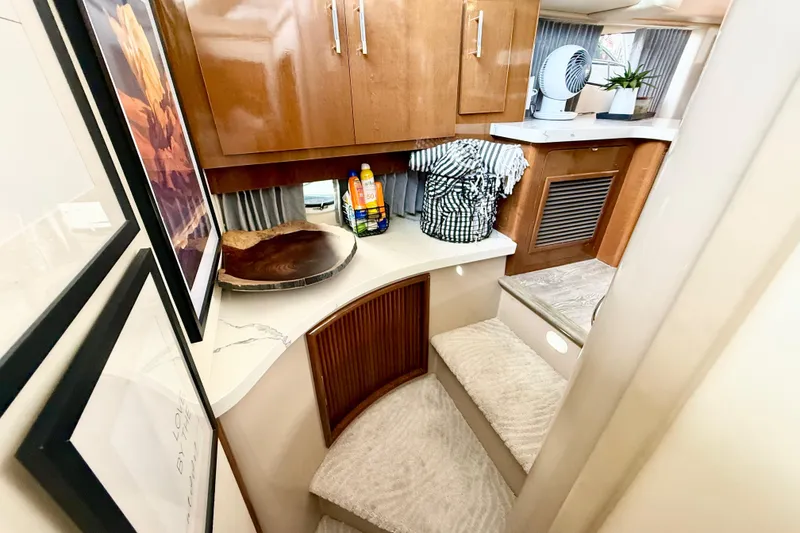 Slide: The Image of Interior of 2007 Carver 36 Sedan with wooden cabinets and carpeted stairs. - 33