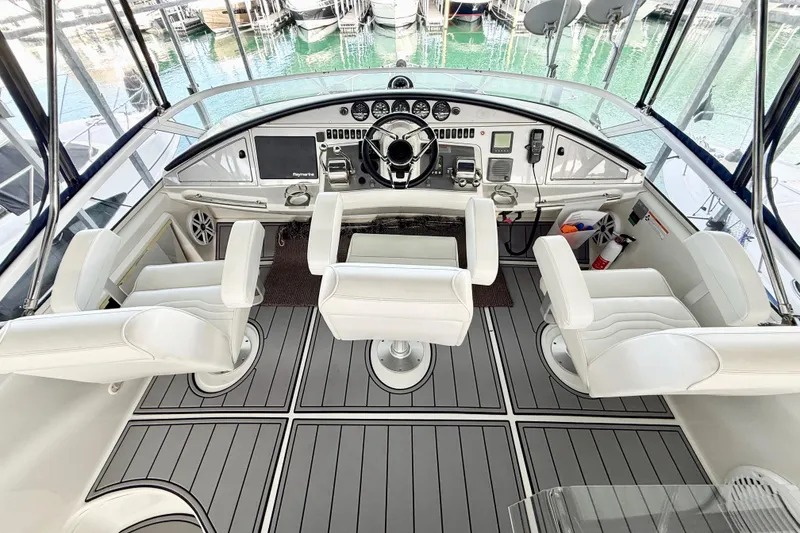 Slide: The Image of Interior view of a 2007 Carver 36 Sedan yacht cockpit with white seating and modern controls. - 36