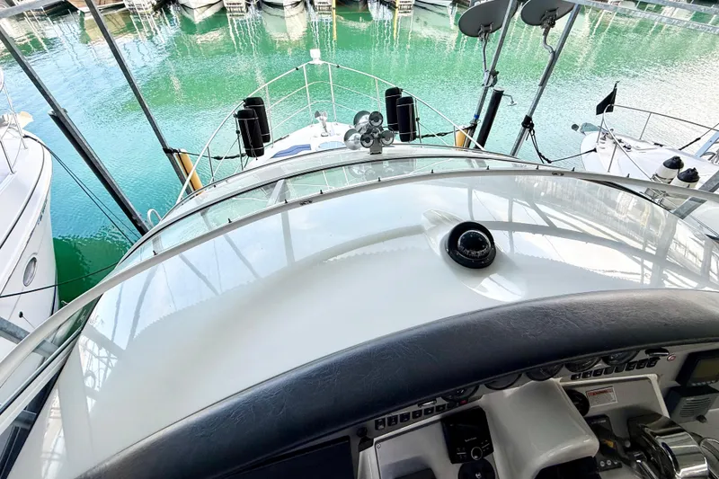 Slide: The Image of 2007 Carver 36 Sedan yacht helm with marina view, showcasing sleek design and navigation equipment. - 38