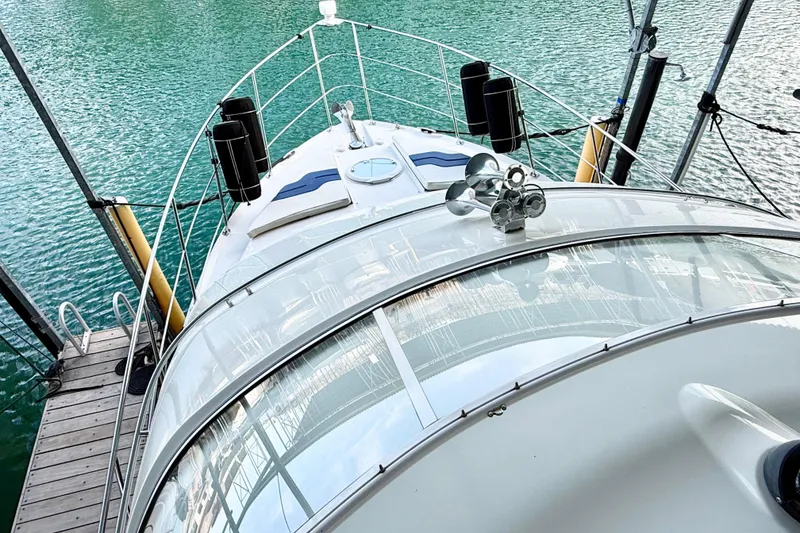 Slide: The Image of 2007 Carver 36 Sedan yacht docked on clear turquoise water. - 50