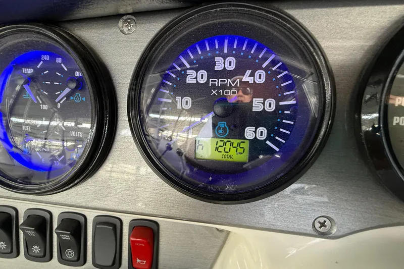 Slide: The Image of Dashboard of a 2007 Carver 36 Sedan showing RPM and gauges. - 53