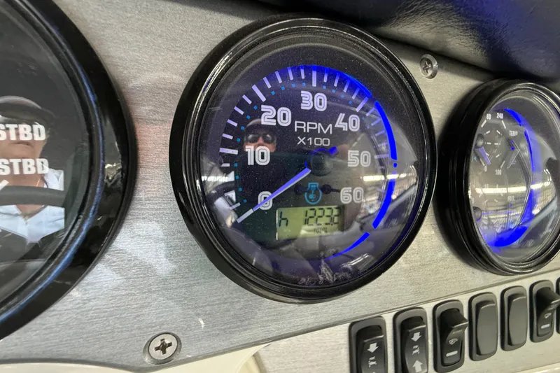 Slide: The Image of Close-up of Carver 36 Sedan 2007 dashboard gauges with RPM and hour display. - 54
