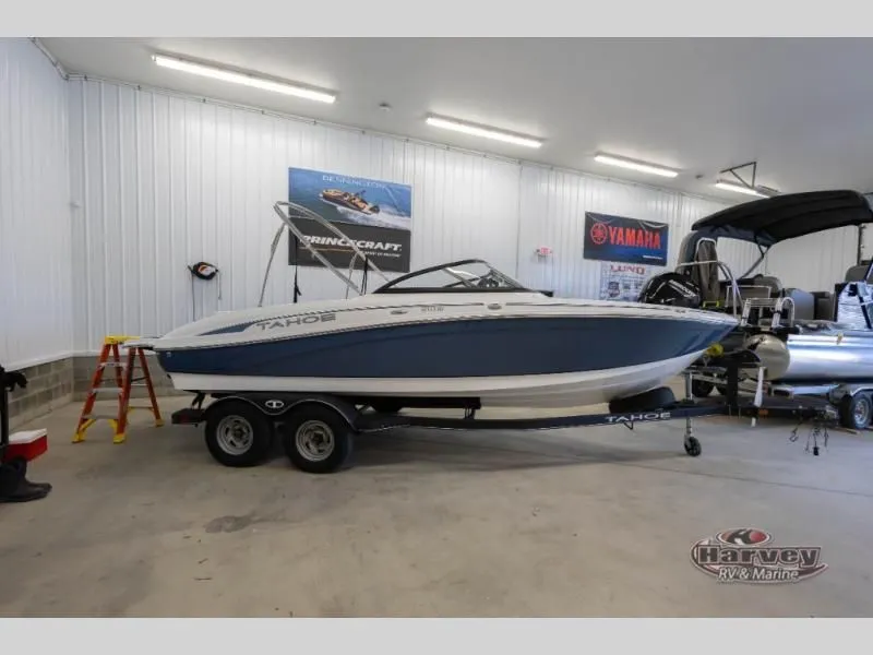 The Image of 2022 Tahoe 210SI boat displayed in a showroom. - 1