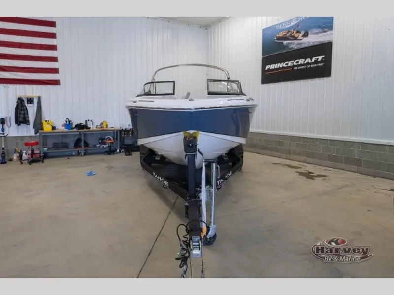 Slide: The Image of 2022 Tahoe 210SI boat in a garage with flag. - 2