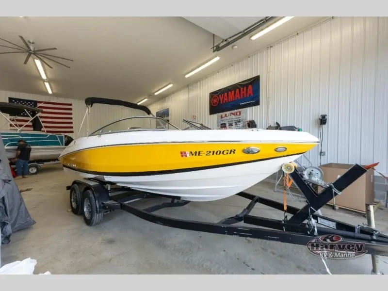 Slide: The Image of Yellow 2014 Regal 2000 boat on trailer in garage. - 6