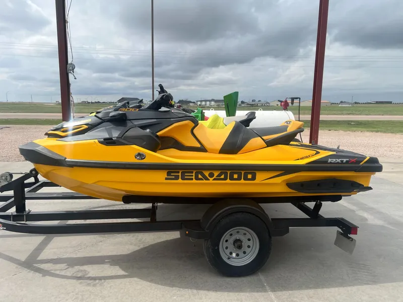 The Image of 2023 Sea-Doo RXT-X 300 IBR on trailer, yellow and black. - 1