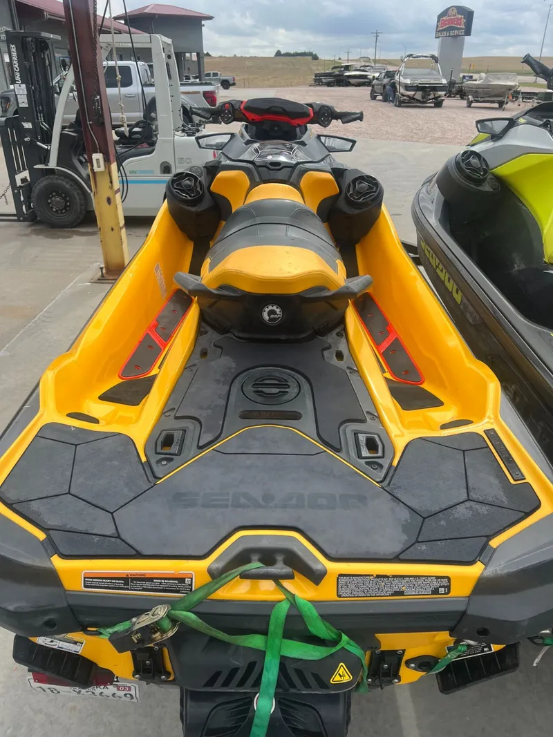 Slide: The Image of 2023 Sea-Doo RXT-X 300 IBR jet ski in vibrant yellow. - 2