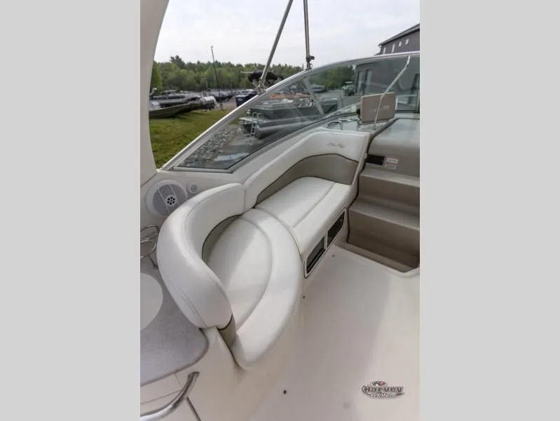 Slide: The Image of Interior of a 2005 SUNDANCER 260 boat with beige seating area. - 12