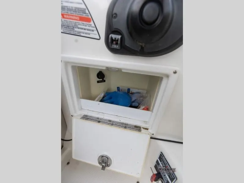 Slide: The Image of Storage compartment in 2005 SUNDANCER 260 boat with gloves. - 21