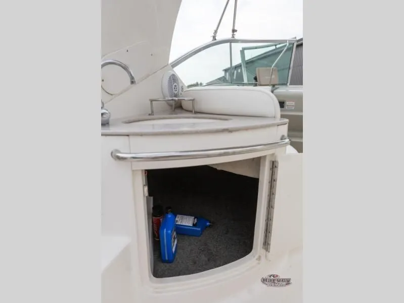 Slide: The Image of Interior of 2005 SUNDANCER 260 with storage and cleaning supplies. - 23