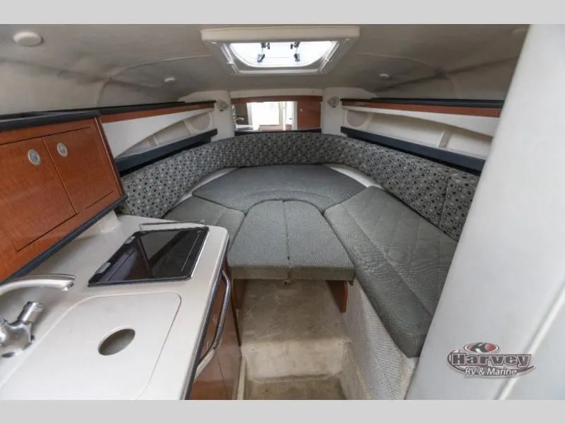 Slide: The Image of Interior of a 2005 SUNDANCER 260 boat with kitchenette and sleeping area. - 26