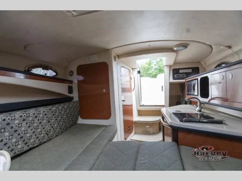 Slide: The Image of Interior of a 2005 SUNDANCER 260 yacht with kitchen and seating area. - 32