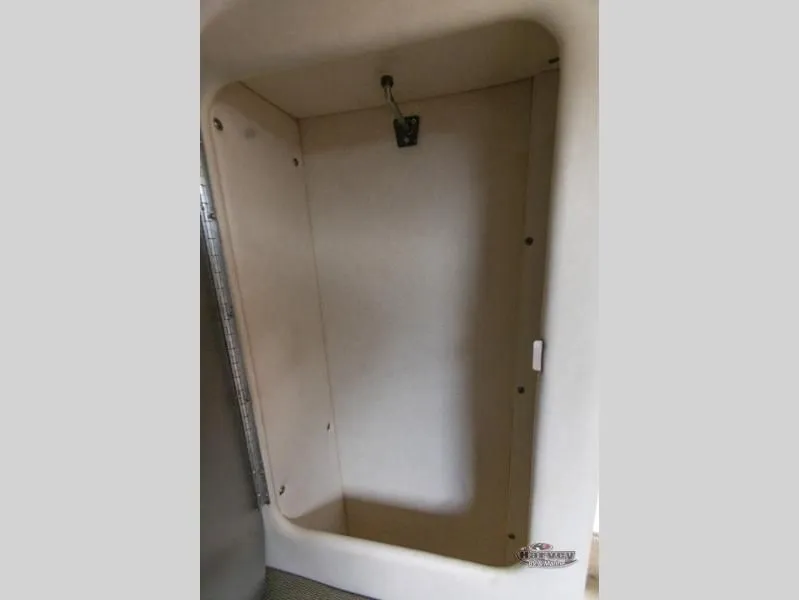 Slide: The Image of Interior of a 2005 SUNDANCER 260 boat, empty storage space. - 34