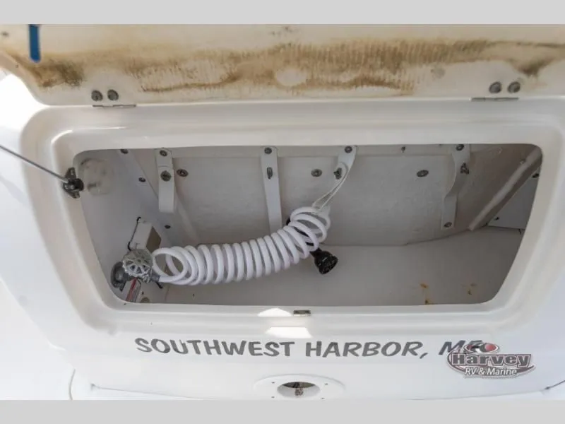 Slide: The Image of Storage compartment of a 2005 SUNDANCER 260 boat with coiled cable. - 9