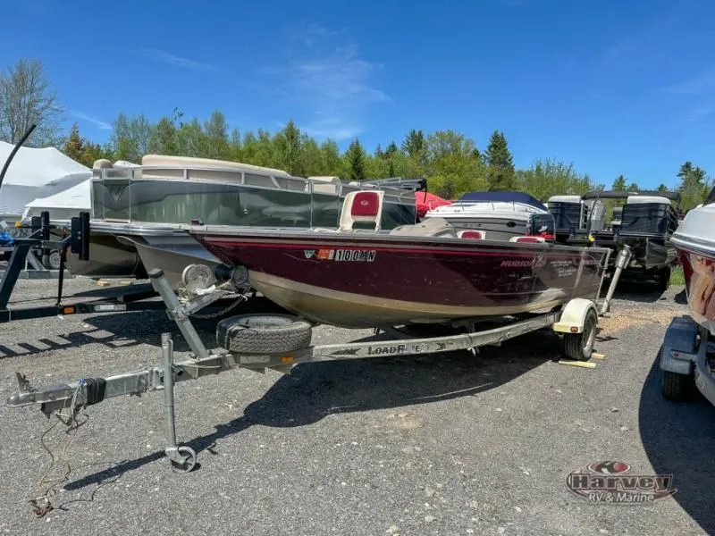 The Image of 2002 Hudson 19 DLX boat on trailer parked outdoors. - 1