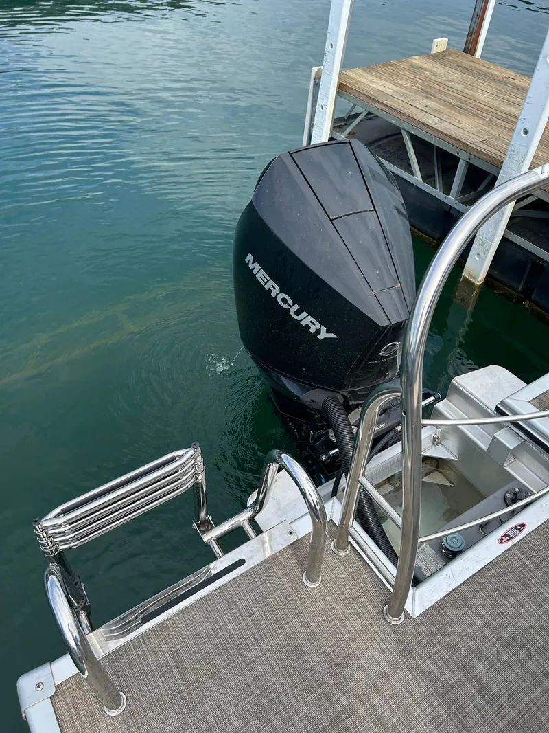 Slide: The Image of Harris Sunliner 250 boat with Mercury outboard motor at dock. - 11